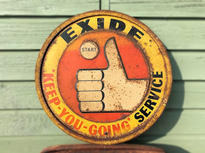 Original embossed painted tin Exide battery sign