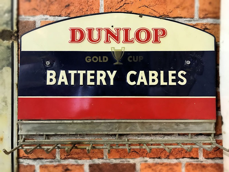 Original embossed painted tin Dunlop battery cables wall mounted display rack