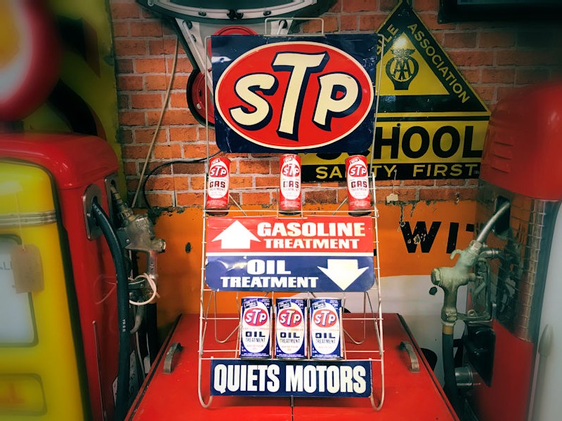 Vintage STP gasoline and oil rack and cans