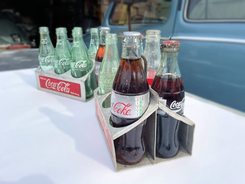 Original aluminium Coca Cola six pack carriers with empty bottles