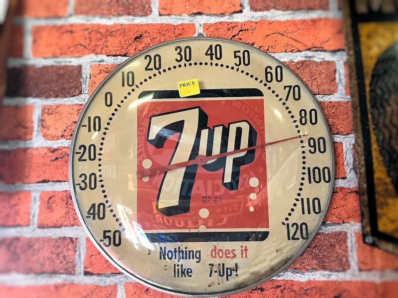Selection of vintage automibilia and 7 Up thermometers