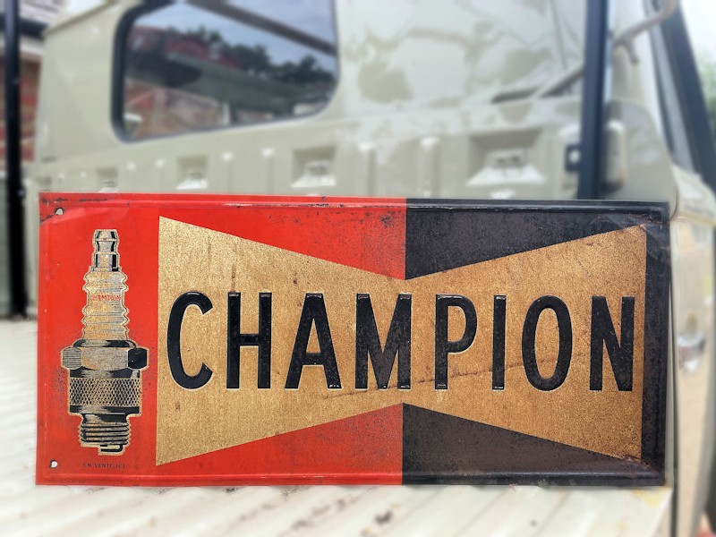 Original painted tin embossed Champion spark plug sign