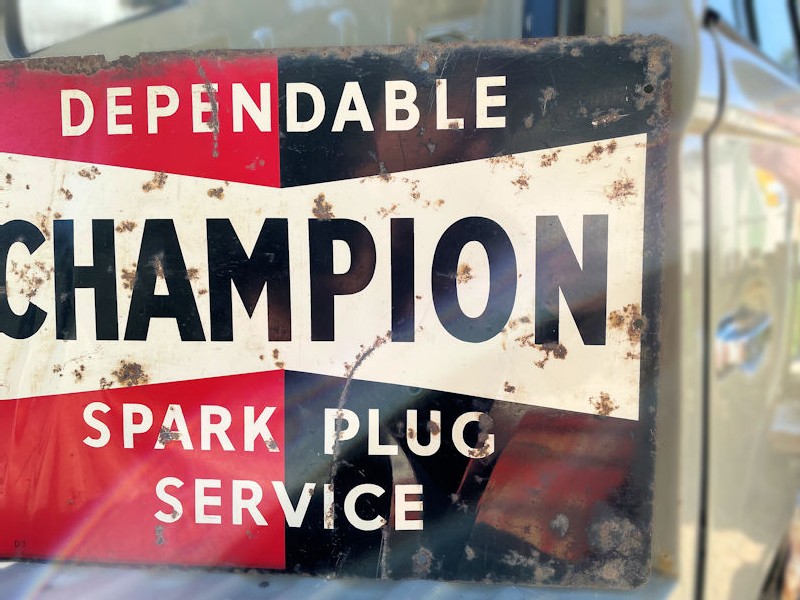 Vintage tin Champion spark plug sign