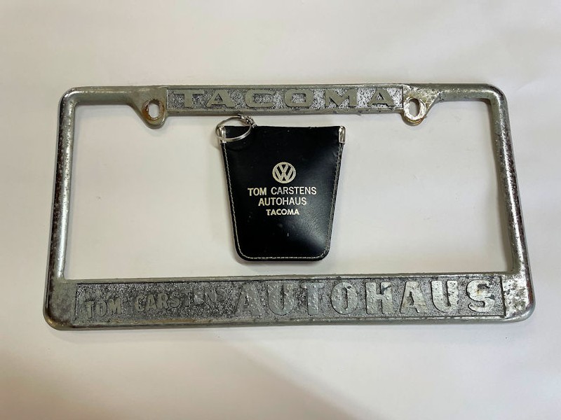 Vintage Tom Carstens Autohaus of Tacoma Volkswagen dealership license plate surround and key pouch